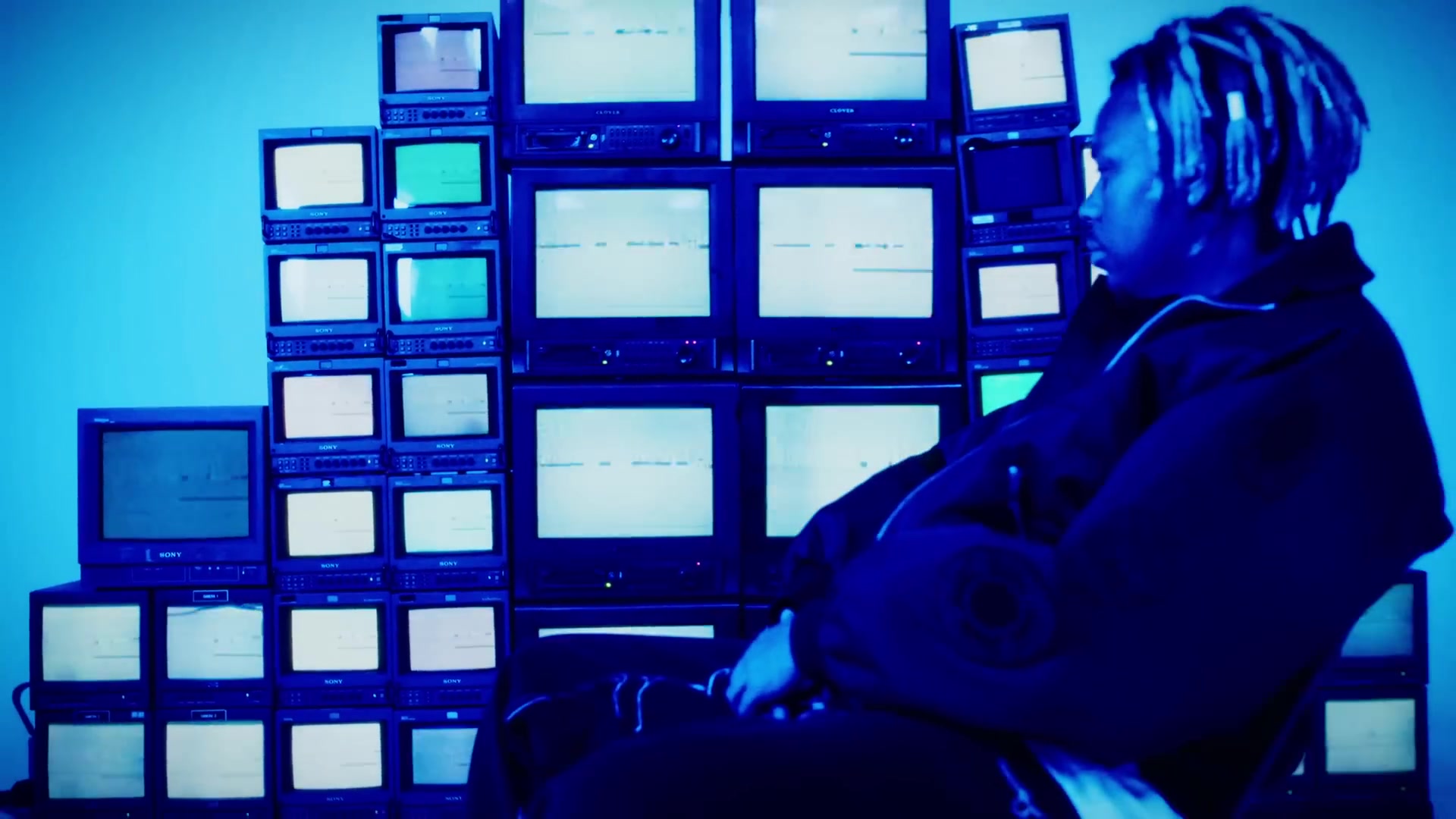 Blue television-wall film still from Mad AF by Cordae